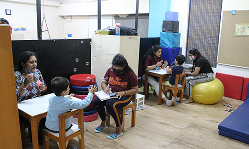 Indian parent reviewing documents related to disability rights and school admission for their autistic child under the RPwD Act 2016