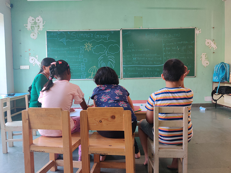 Young Indian child with a school bag standing at a school entrance, representing the journey of autism and schooling in India